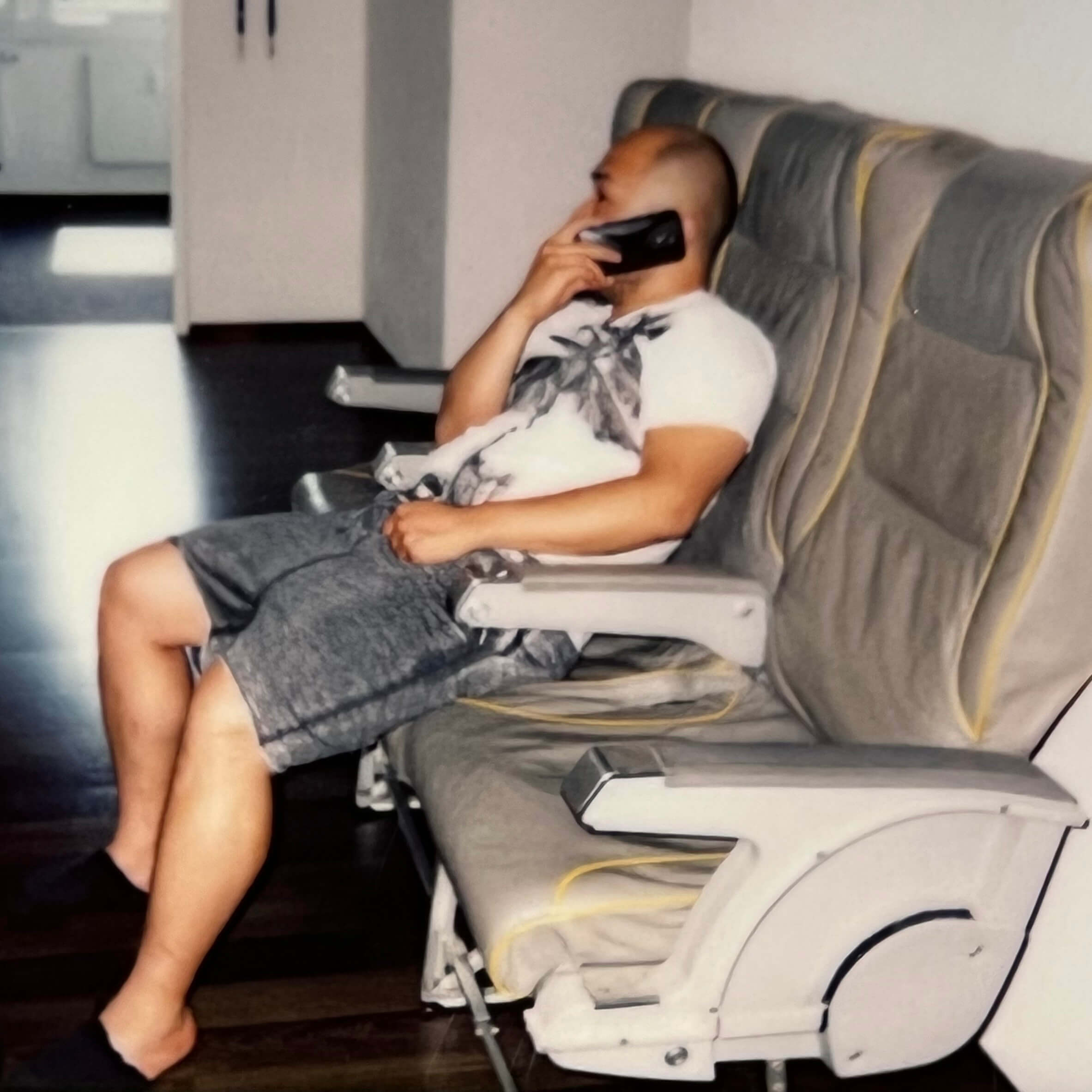 Keen employee sat on comfortable chair taking a phone call